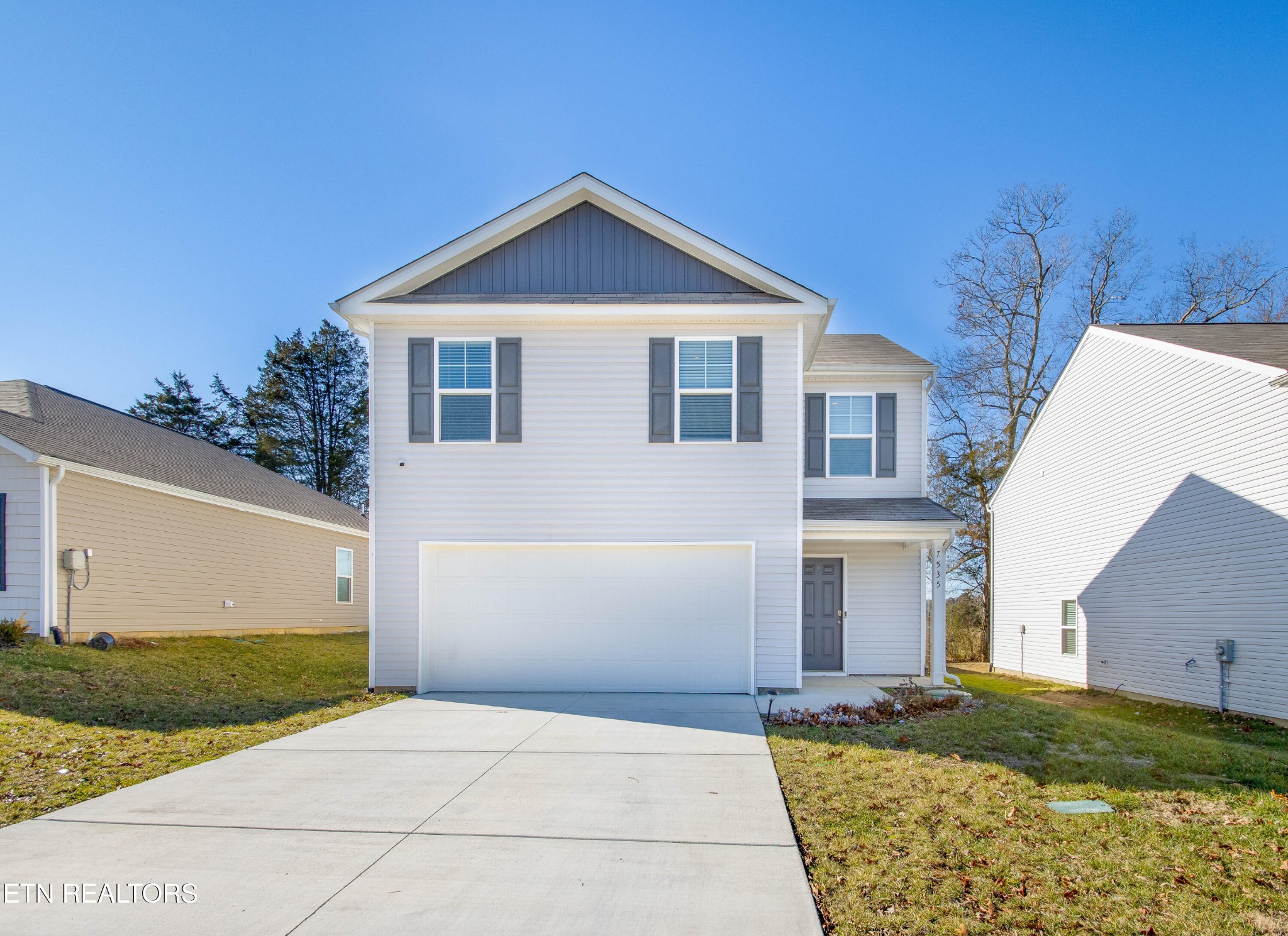 a front view of a house with a yard