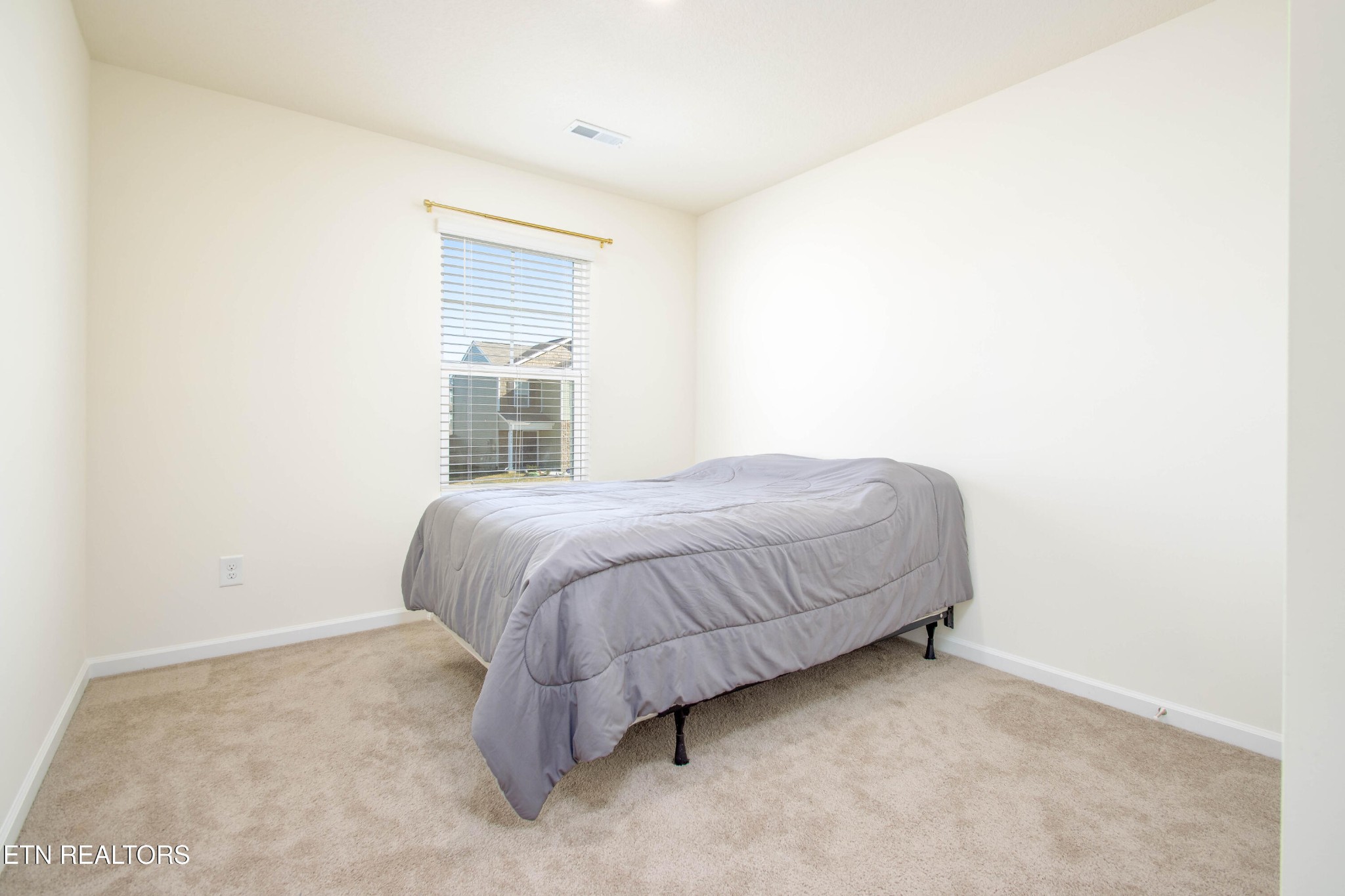 7535 Grasshopper Lane Corryton, TN 37721 - Photo 18 of 28 a spacious bedroom with a bed and a window