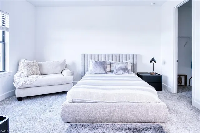 a living room with furniture a table and a large window