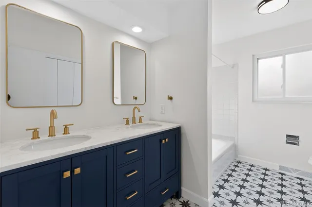 a bathroom with a double vanity sink a mirror and shower