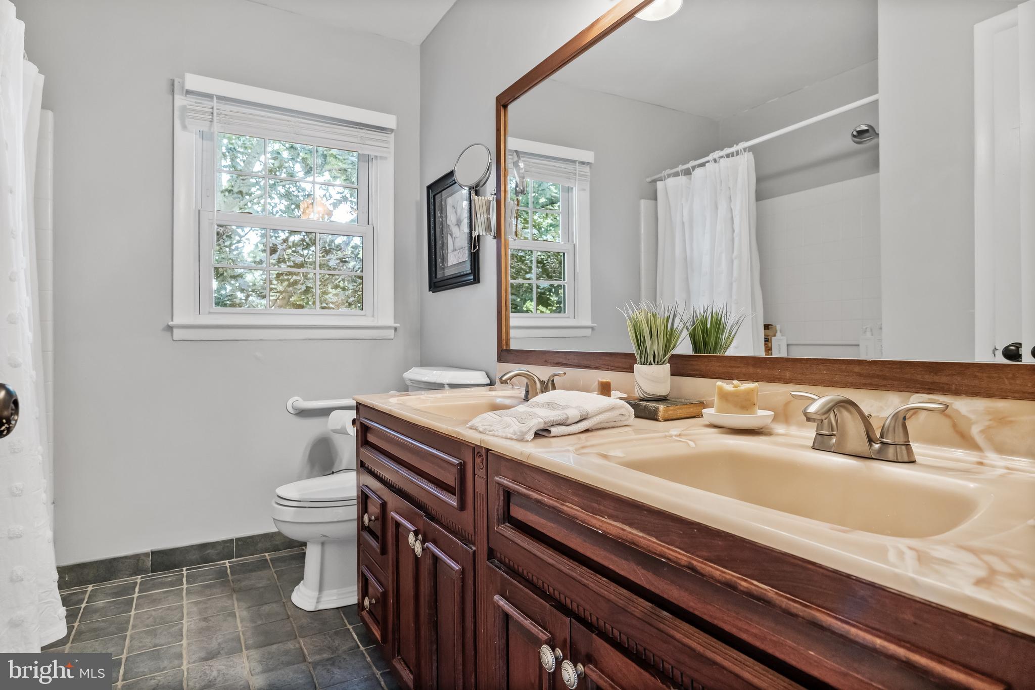 803 Charleston Road Mount Laurel, NJ 08054 - Photo 28 of 36 a bathroom with a granite countertop sink a toilet and a window