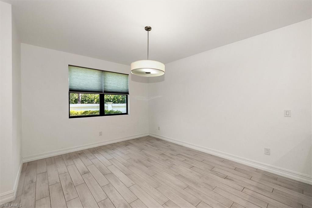 7546 Rockefeller Drive Naples, FL 34119 - Photo 12 of 31 Unfurnished room with light wood finished floors and baseboards