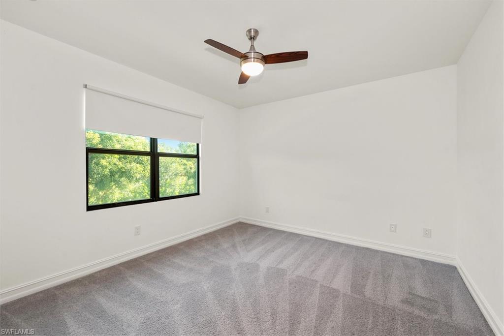7546 Rockefeller Drive Naples, FL 34119 - Photo 17 of 31 Carpeted spare room with baseboards and a ceiling fan