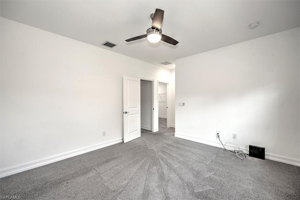 7546 Rockefeller Drive Naples, FL 34119 - Photo 18 of 31 Unfurnished bedroom featuring carpet and a ceiling fan