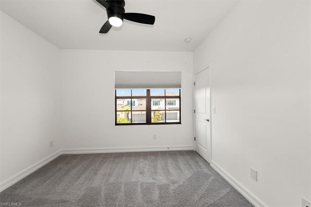 7546 Rockefeller Drive Naples, FL 34119 - Photo 22 of 31 Empty room with carpet floors and ceiling fan
