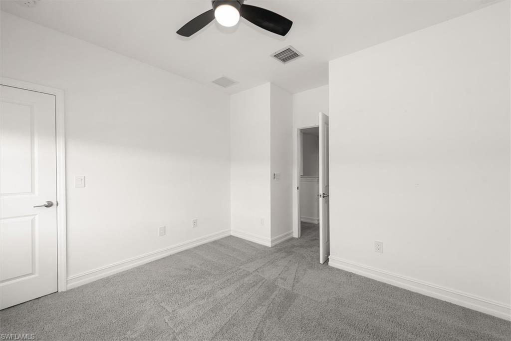 7546 Rockefeller Drive Naples, FL 34119 - Photo 23 of 31 Unfurnished room with carpet floors and a ceiling fan