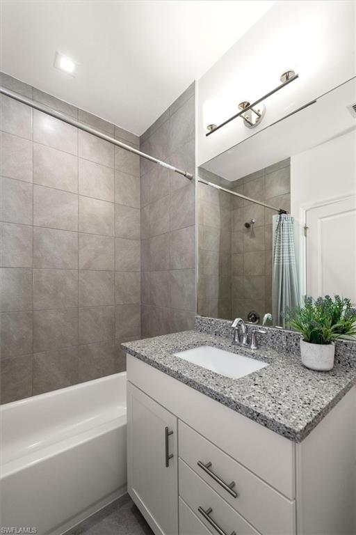 7546 Rockefeller Drive Naples, FL 34119 - Photo 24 of 31 Bathroom with vanity and shower / tub combo with curtain