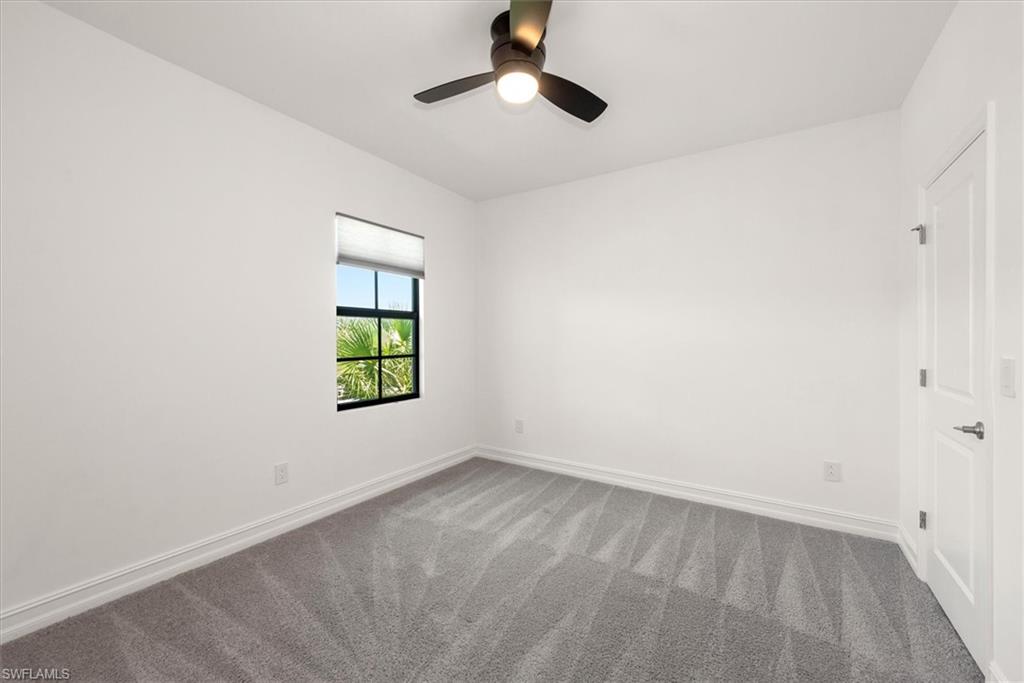 7546 Rockefeller Drive Naples, FL 34119 - Photo 25 of 31 Carpeted empty room with baseboards and ceiling fan