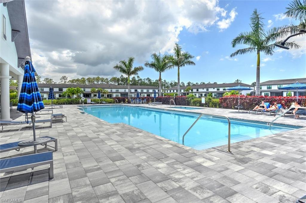 7546 Rockefeller Drive Naples, FL 34119 - Photo 29 of 31 Community pool with a hot tub and a patio