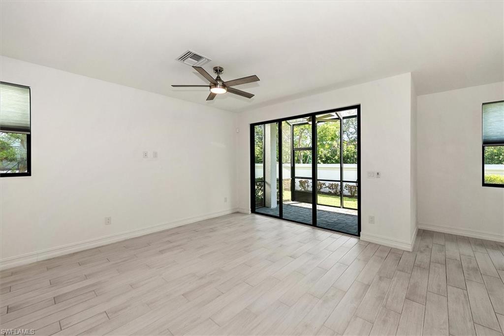 7546 Rockefeller Drive Naples, FL 34119 - Photo 7 of 31 Spare room with healthy amount of natural light, light wood-style flooring, and a ceiling fan