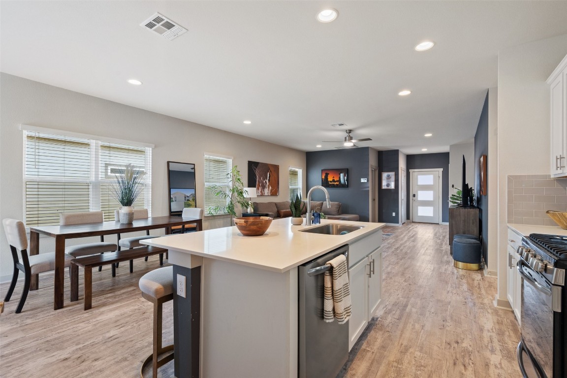 8313 City Top Boulevard Austin, TX 78724 - Photo 13 of 37 a large kitchen with lots of counter space a sink appliances and a dining table