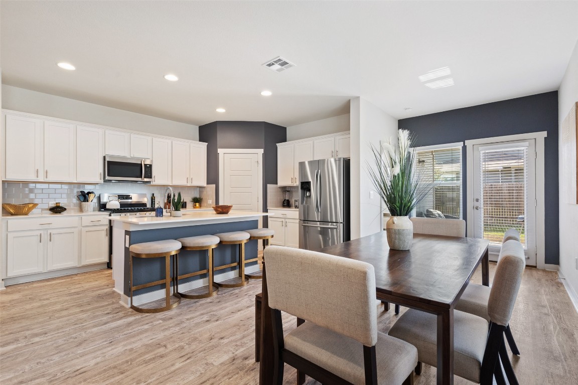 8313 City Top Boulevard Austin, TX 78724 - Photo 14 of 37 a kitchen with a table chairs refrigerator and cabinets