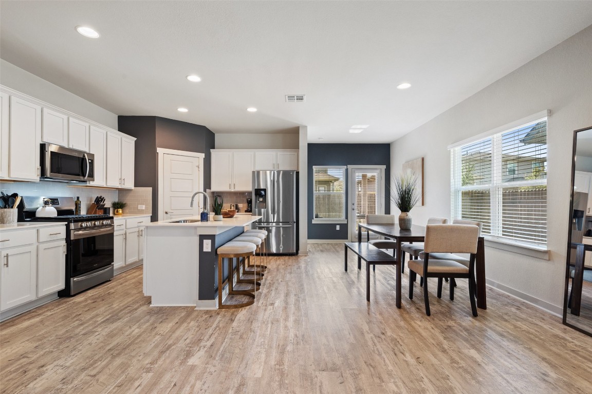 8313 City Top Boulevard Austin, TX 78724 - Photo 15 of 37 a kitchen with a dining table chairs and refrigerator