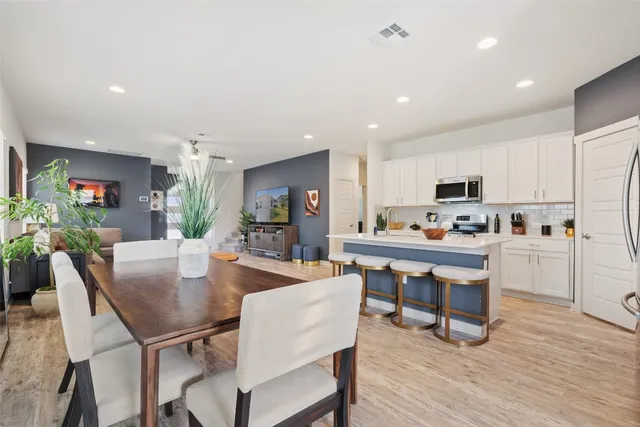 a view of kitchen with cabinets table and chairs