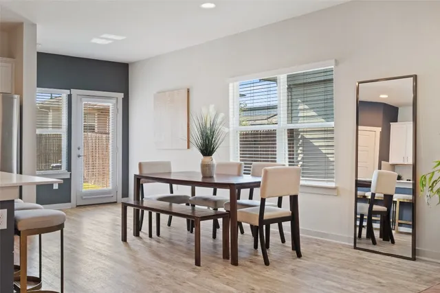 a view of a dining room with furniture and windows