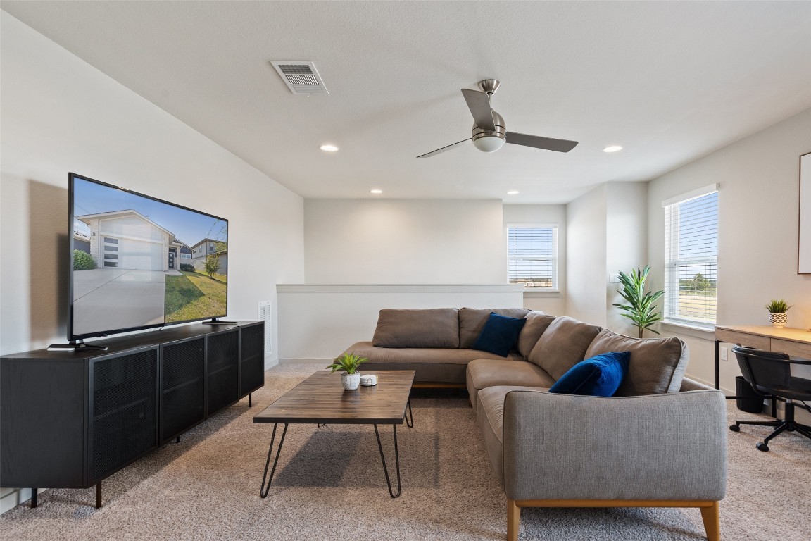 8313 City Top Boulevard Austin, TX 78724 - Photo 18 of 37 a living room with furniture a flat screen tv and kitchen view