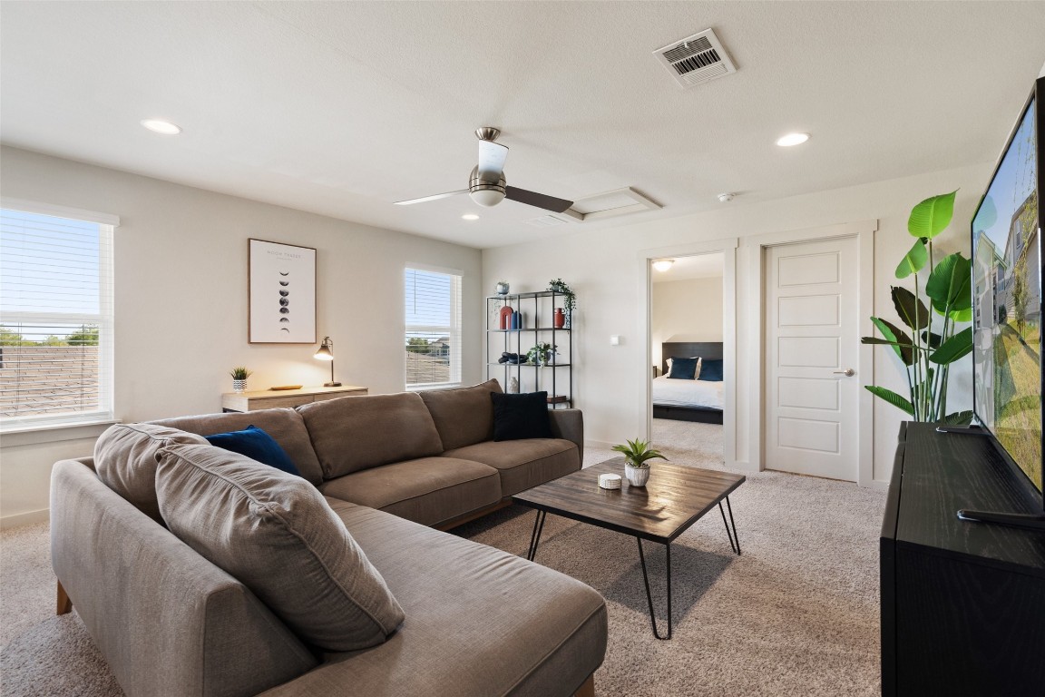 8313 City Top Boulevard Austin, TX 78724 - Photo 20 of 37 a living room with furniture and a potted plant