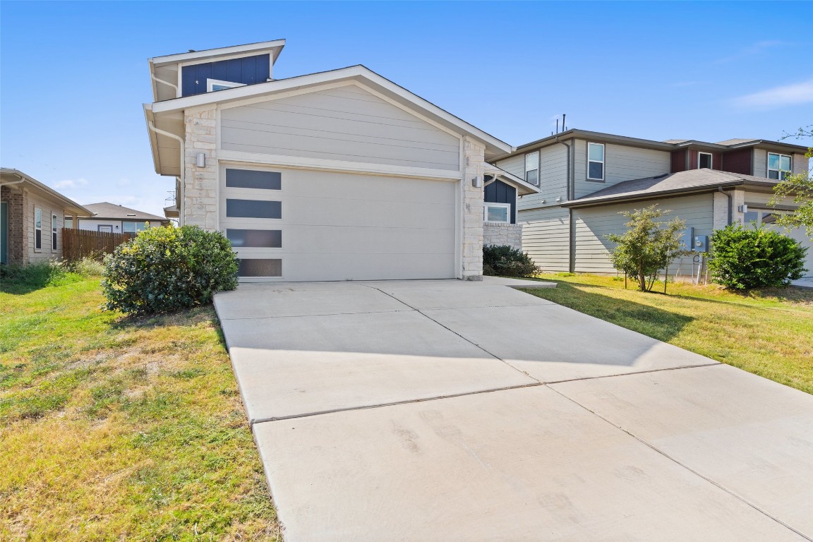8313 City Top Boulevard Austin, TX 78724 - Photo 2 of 37 a front view of a house with a yard and potted plants