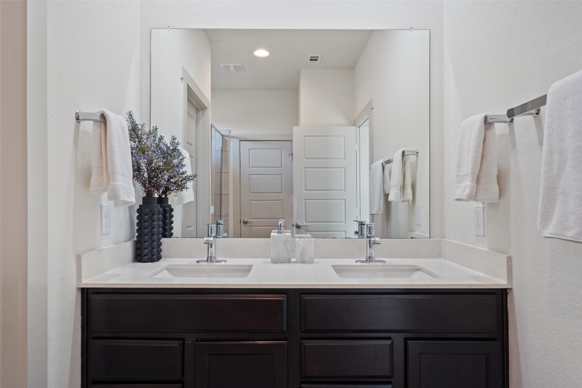 8313 City Top Boulevard Austin, TX 78724 - Photo 26 of 37 a bathroom with double vanity and a mirror