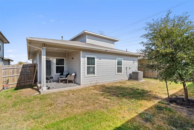 a view of a house with backyard and sitting area