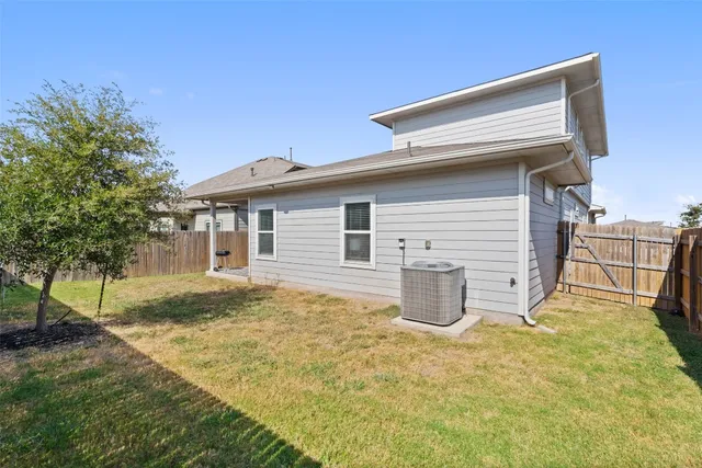 a backyard of a house with barbeque oven table and chairs