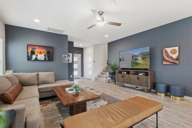 a living room with furniture and a flat screen tv
