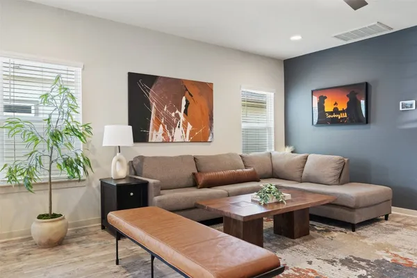 a living room with furniture potted plant and a window