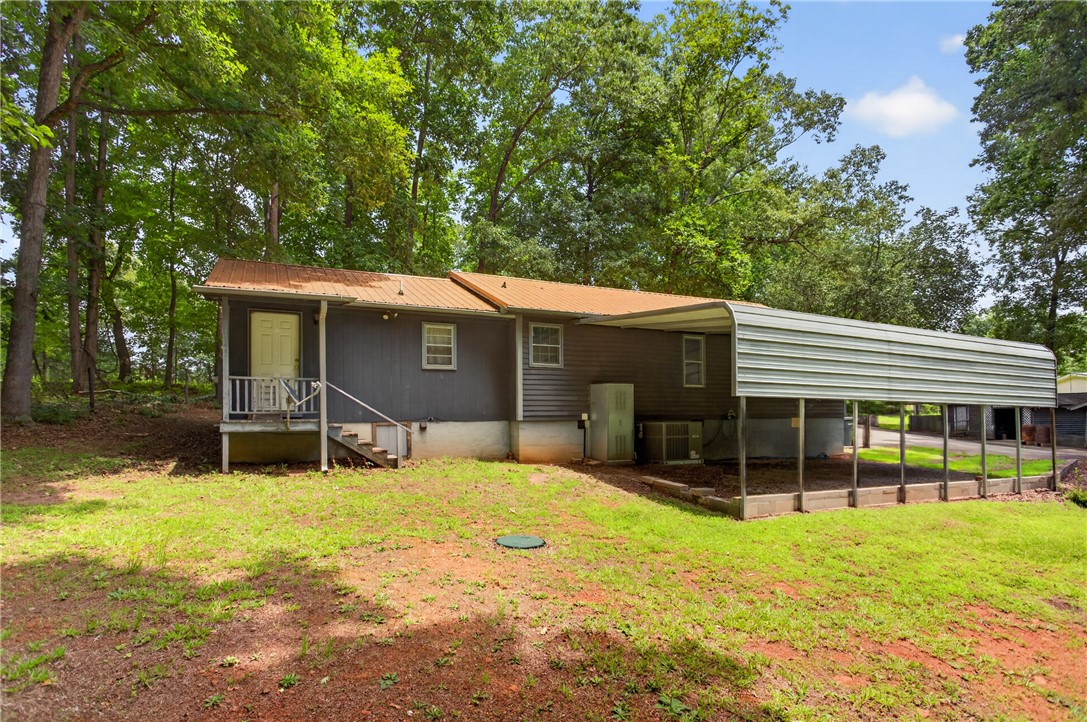 230 Dickard Road Seneca, SC 29672 - Photo 22 of 25 Rural retreat with ample covered parking amidst a verdant, natural setting.