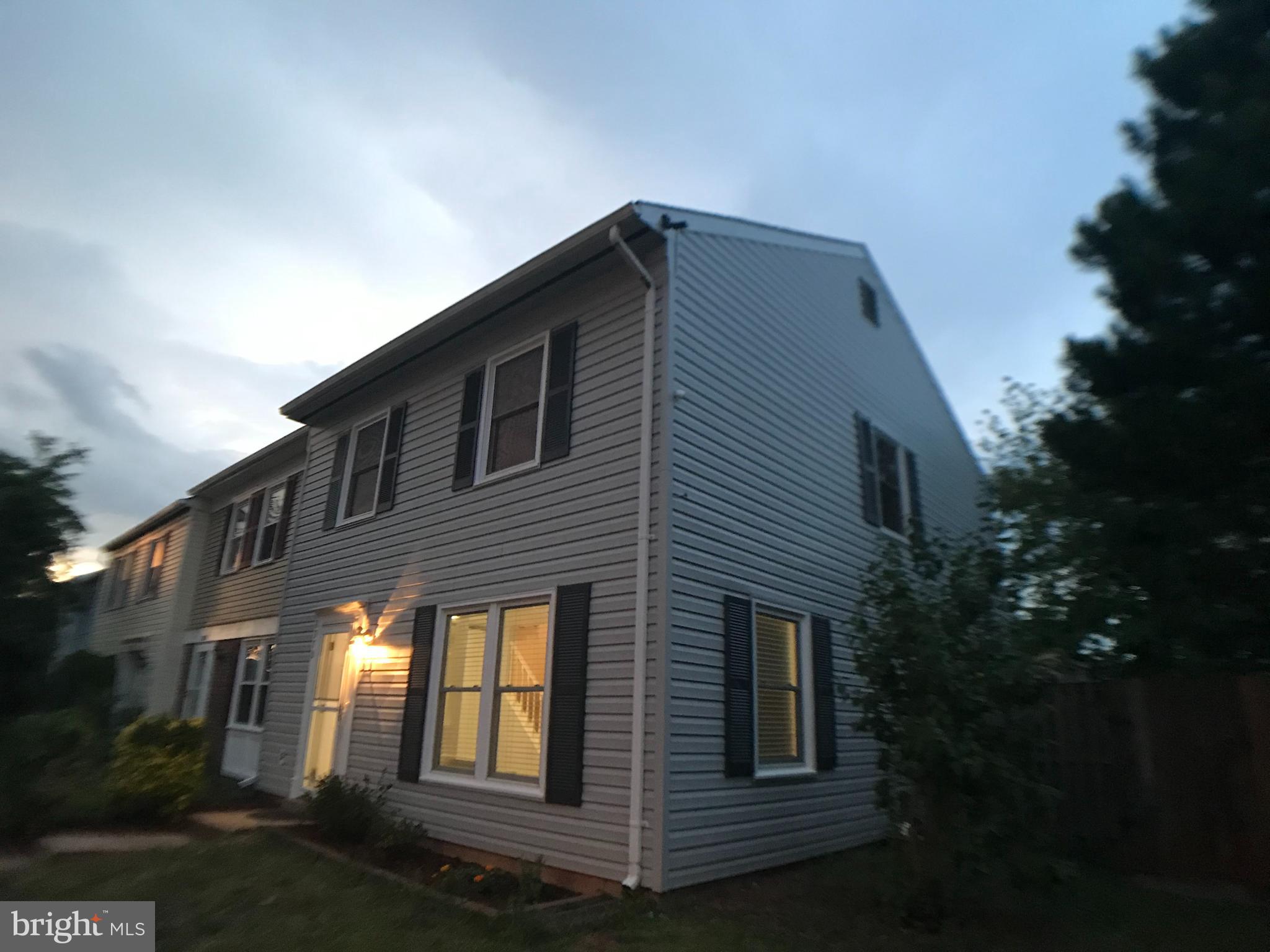 8970 Miles Place Manassas, VA 20110 - Photo 1 of 12 a front view of a house with garage