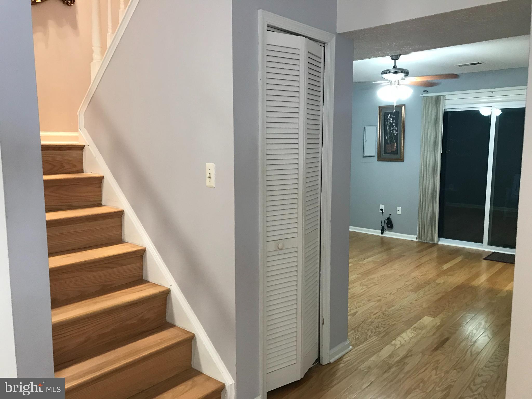 8970 Miles Place Manassas, VA 20110 - Photo 12 of 12 a view of a hallway with wooden floor and staircase