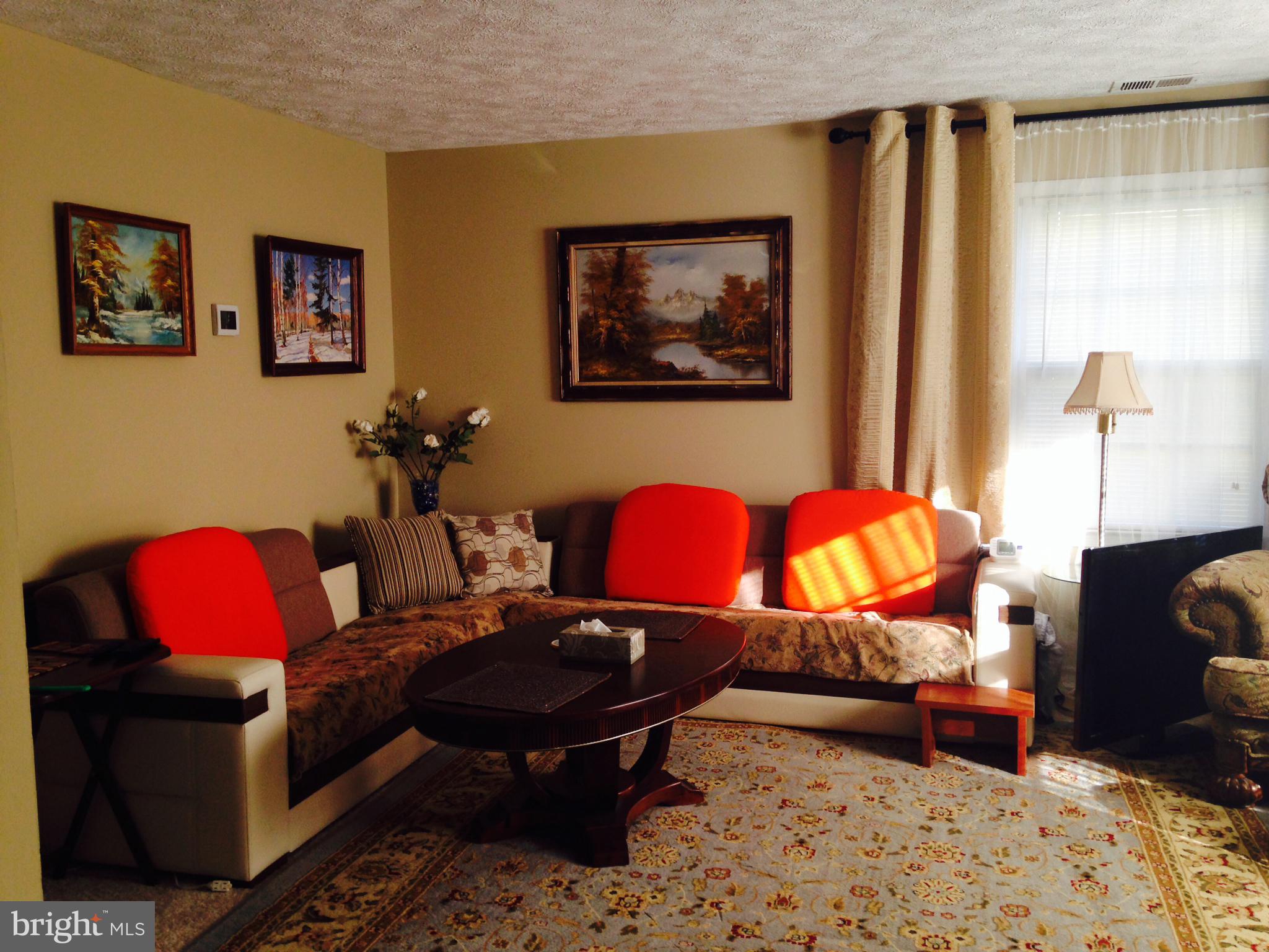 8970 Miles Place Manassas, VA 20110 - Photo 4 of 12 a living room with furniture a red couch and a dresser