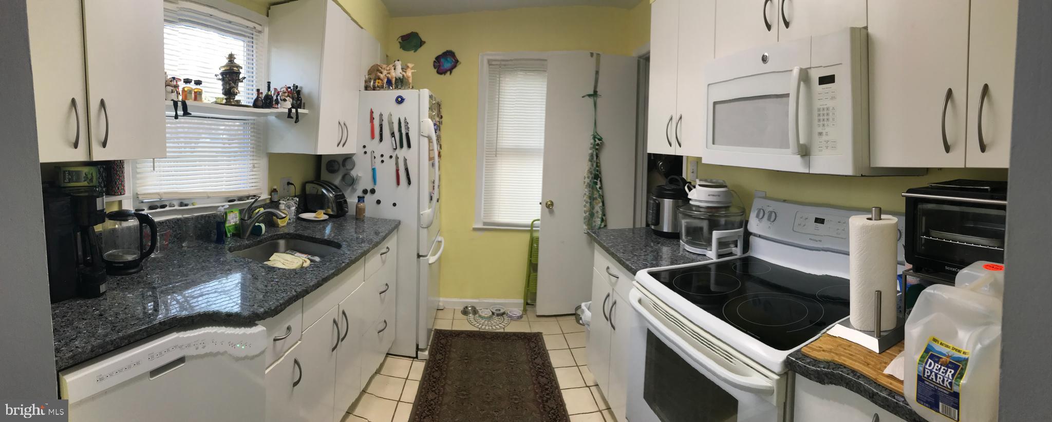 8970 Miles Place Manassas, VA 20110 - Photo 6 of 12 a kitchen with stainless steel appliances granite countertop a sink dishwasher stove and refrigerator