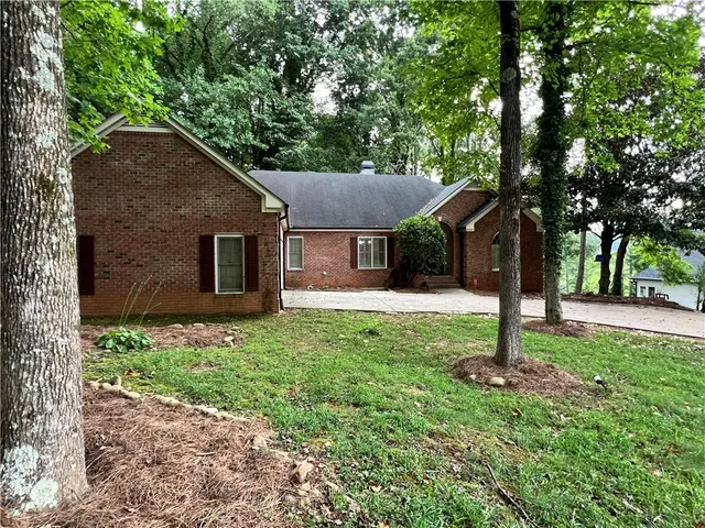a house that has a tree in front of it