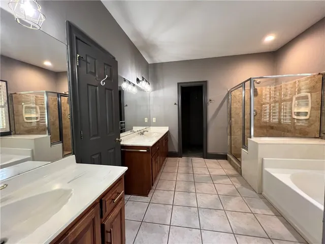 a large bathroom with a large mirror vanity and a sink