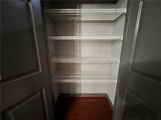 a view of an empty room and a window