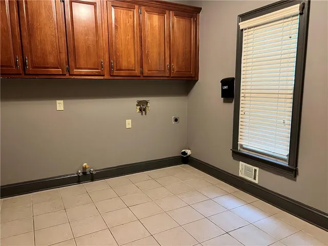 a kitchen with stainless steel appliances kitchen island granite countertop a refrigerator a stove and a sink