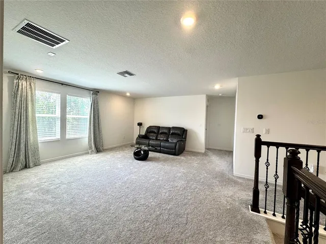 a big room with furniture and a flat screen tv