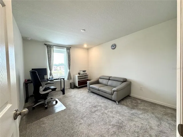 a living room with furniture gym equipment and a view of living room