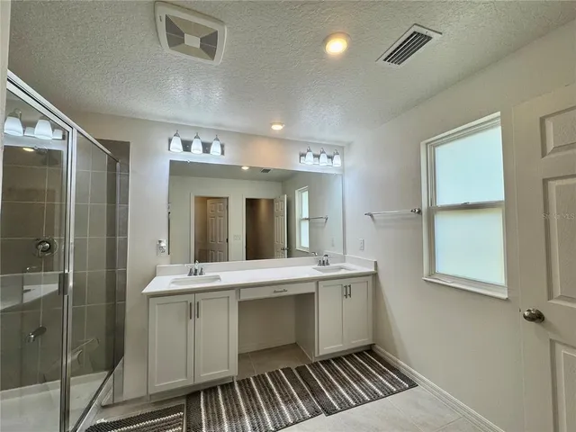 a bathroom with a sink mirror and vanity