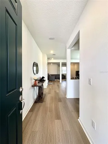 a view of a living room kitchen and a wooden floor