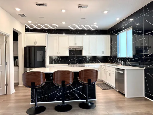 a kitchen with a sink cabinets and window