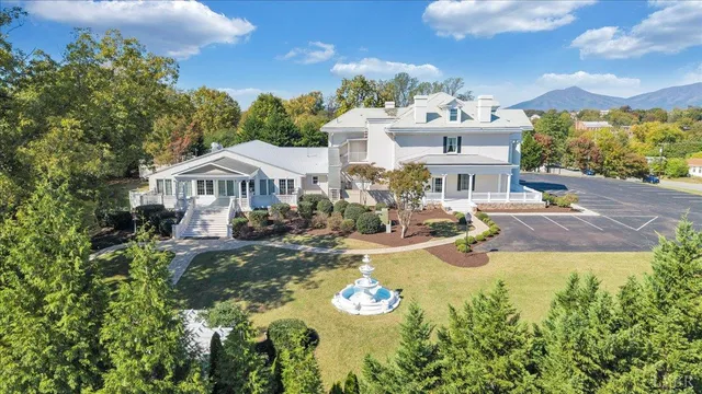 a view of a house with swimming pool and sitting area