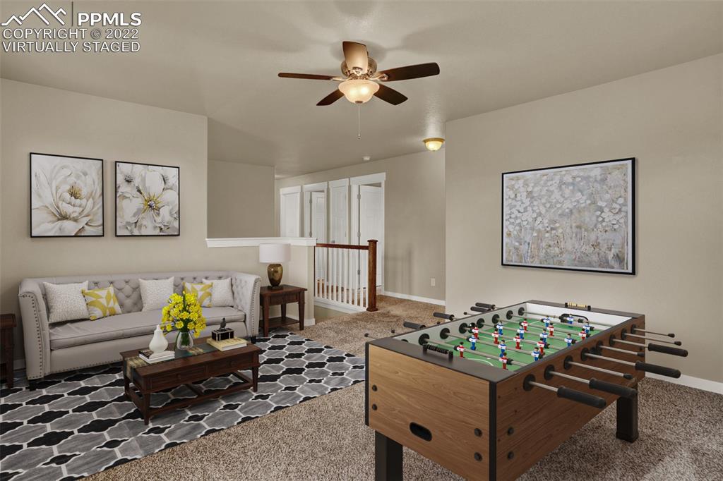 6750 Alliance Loop Colorado Springs, CO 80925 - Photo 15 of 32 a living room with furniture and wooden floor