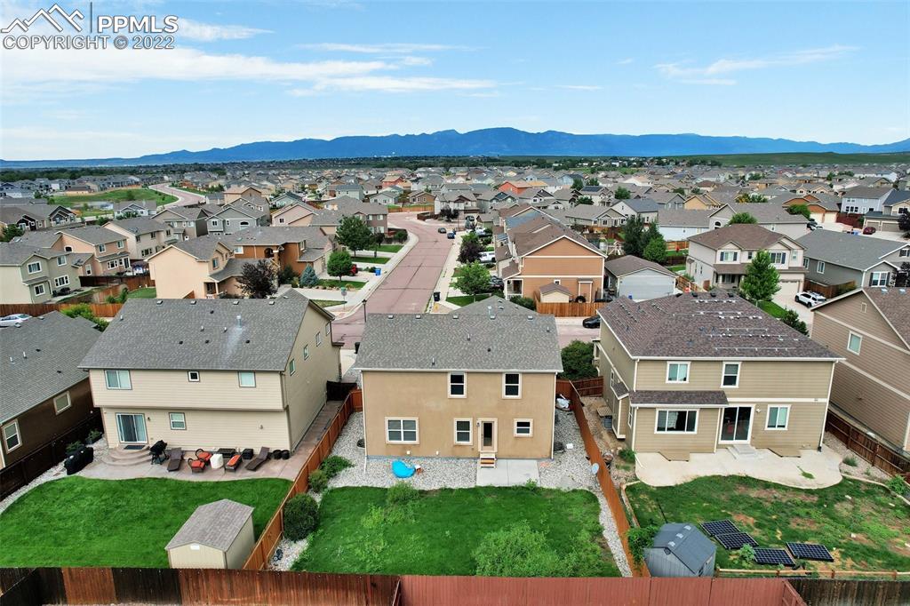 6750 Alliance Loop Colorado Springs, CO 80925 - Photo 32 of 32 an aerial view of multiple houses with a yard
