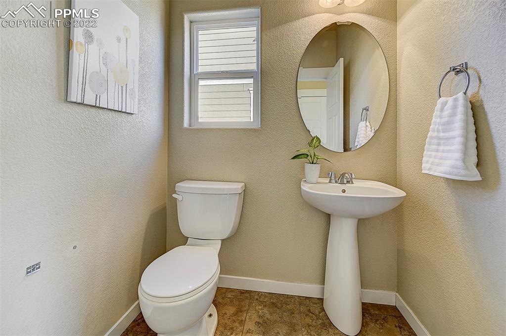 6750 Alliance Loop Colorado Springs, CO 80925 - Photo 10 of 32 a bathroom with a toilet sink and mirror
