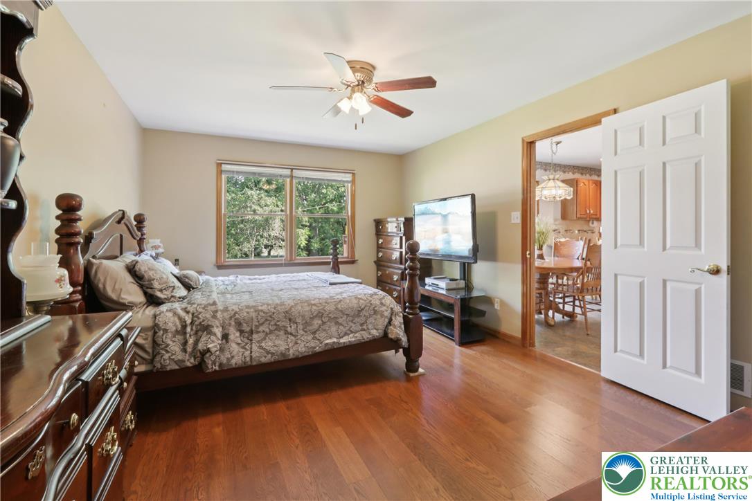 1705 Deer Path Road Easton, PA 18040 - Photo 17 of 42 a bedroom with a large bed and a chandelier