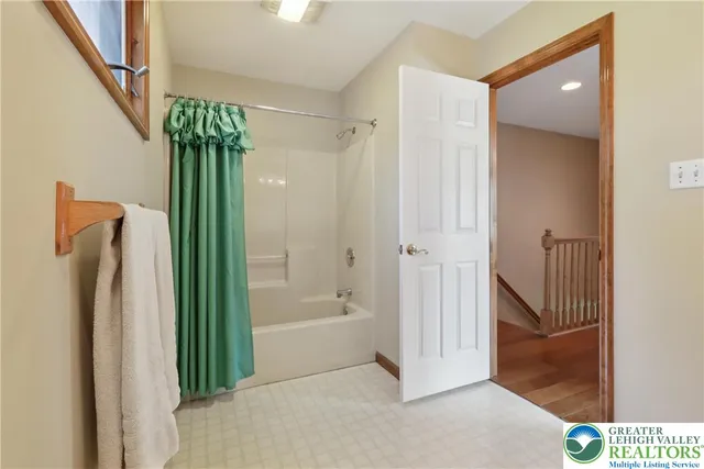 a bathroom with a shower and a bath tub