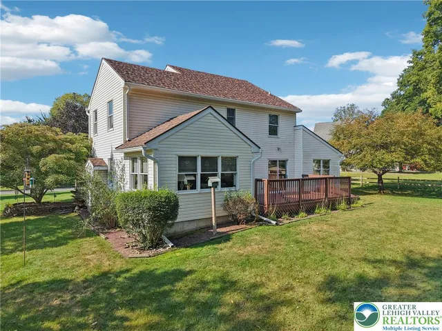 a view of a house with a yard porch and sitting area