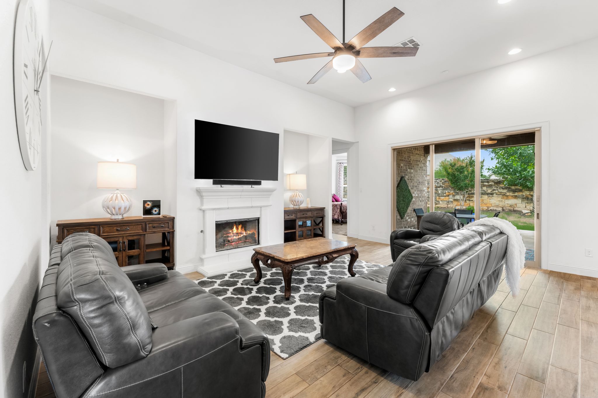 140 Waterloo Cove Georgetown, TX 78628 - Photo 18 of 40 A comforting fireplace anchors this well-lit living area, featuring ample seating and an inviting outdoor view.
