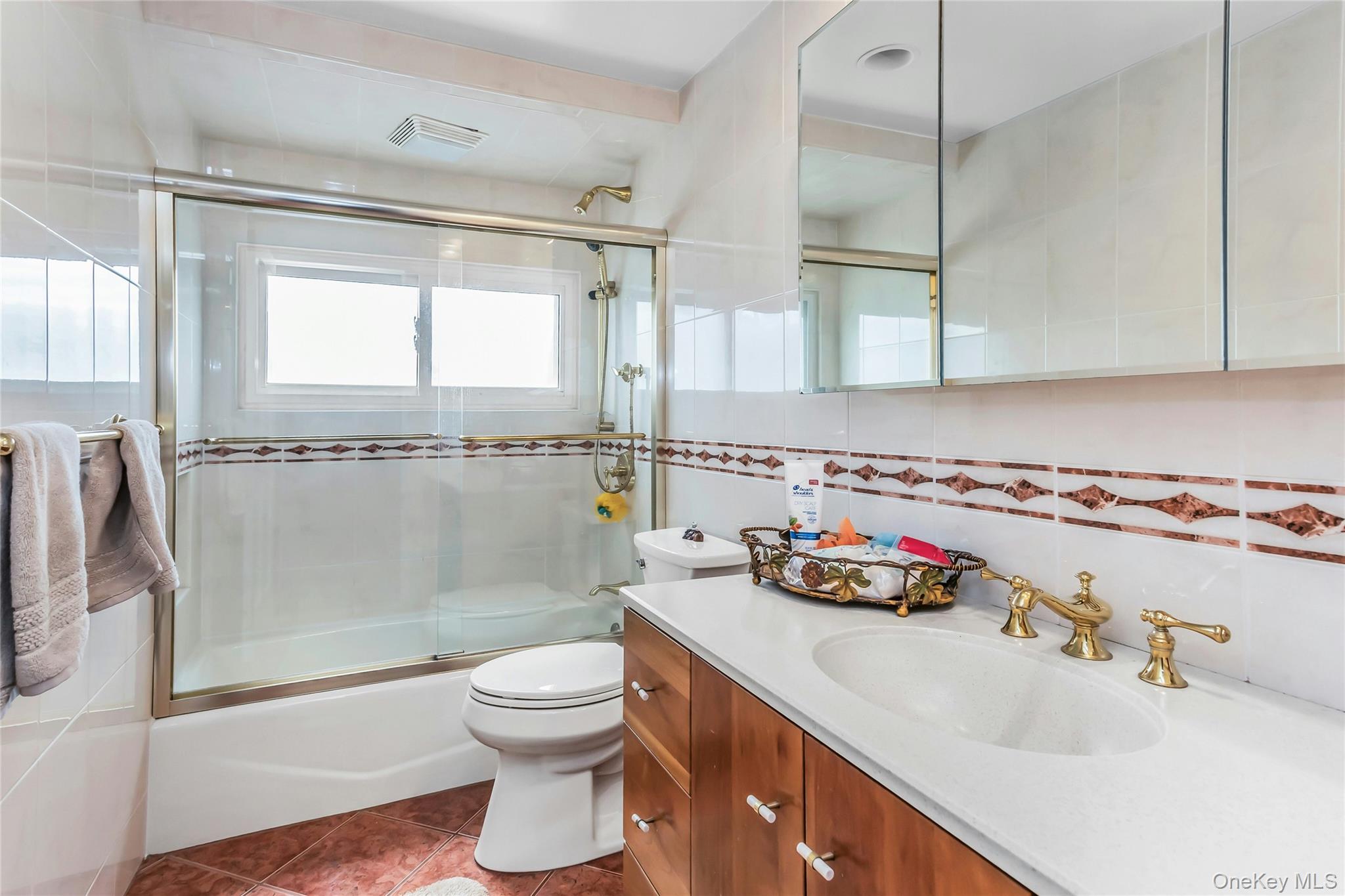 57 Joyce Road Plainview, NY 11803 - Photo 16 of 20 a bathroom with a sink toilet and shower